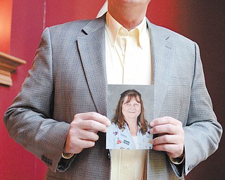 D'Wayne Robinson holds a photo of his wife, Teresa, who passed away April 27, 2013, after a long battle with cancer.