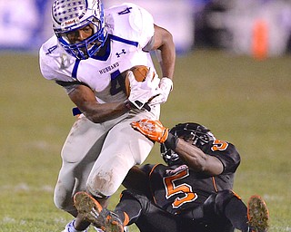 Jeff Lange | The Vindicator  Hubbard's George Hill drags along Ameer Williamson (5) of Howland as he makes his way downfield in the second quarter of their game, Friday night in Howland.