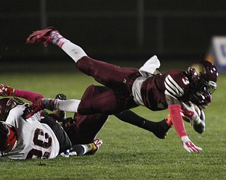  .          ROBERT  K. YOSAY | THE VINDICATOR..Girard at Liberty as Liberty ..Libertys #3 Michael Rushton gets tripped ub by girards #20 Chaston Williams but still manages a few yards during second half action..-30-