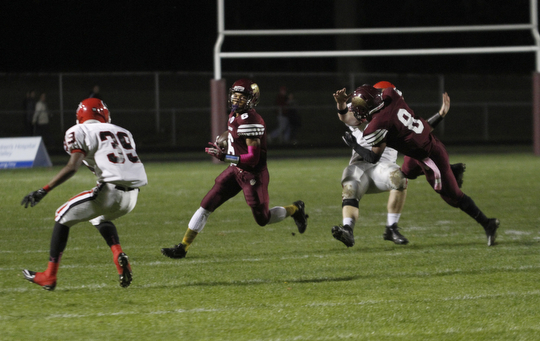 ROBERT  K. YOSAY | THE VINDICATOR.Girard at Liberty as Liberty ..Libertys  Lynn Bowden takes off  for a first down  after Libertys #8 Alex Carnathan takes out Girards #8  Anthony Backus - Girards #39 is waiting  Collin Harden as Bowden went 432 yards for the score.