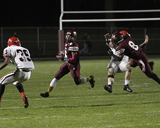 ROBERT  K. YOSAY | THE VINDICATOR.Girard at Liberty as Liberty ..Libertys  Lynn Bowden takes off  for a first down  after Libertys #8 Alex Carnathan takes out Girards #8  Anthony Backus - Girards #39 is waiting  Collin Harden as Bowden went 432 yards for the score.