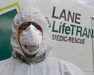        ROBERT K. YOSAY  | THE VINDICATOR...Seth Durig of Lane Life-Trans  - shows off a level C containment suit.  typically worn - for treating infected people ..-30-
