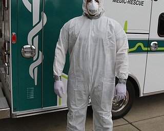        ROBERT K. YOSAY  | THE VINDICATOR...Seth Durig of Lane Life-Trans  - shows off a level C containment suit.  typically worn - for treating infected people ..-30-