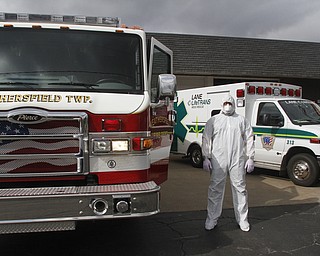        ROBERT K. YOSAY  | THE VINDICATOR...Seth Durig of Lane Life-Trans  - shows off a level C containment suit.  typically worn - for treating infected people ..-30-