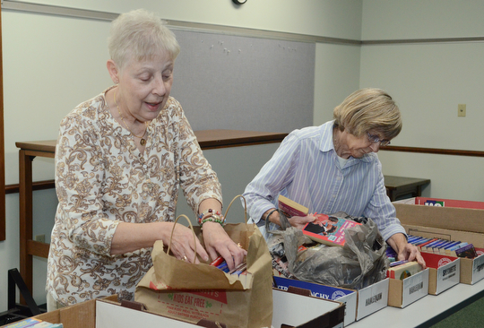 Katie Rickman | The Vindicator.Friends of the Library members Andrea Gates, on left, and Dayne Fitzsimmons sort books that will be sold at the Hubbard Public Library book sale Oct. 22-Oct. 25, 2014 on Wednesday, Oct. 15, 2014 at the library.