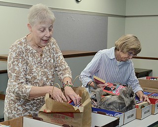 Katie Rickman | The Vindicator.Friends of the Library members Andrea Gates, on left, and Dayne Fitzsimmons sort books that will be sold at the Hubbard Public Library book sale Oct. 22-Oct. 25, 2014 on Wednesday, Oct. 15, 2014 at the library.