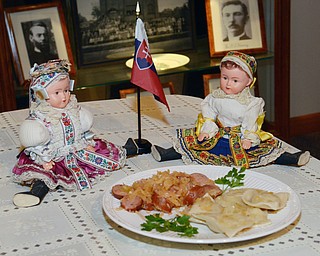 Katie Rickman | The VindicatorDolls from Slovakia sit behind a traditional meal of pierogi and kielbasa at Bethel Lutheran Church where the annual international dinner on October 25, 2014.
