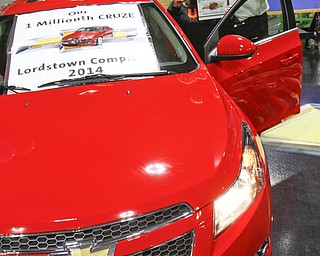        ROBERT K. YOSAY  | THE VINDICATOR..Sharon Frey of Mineral RIdge.. holds the certificate that the car is the 1 millionith Cruze built shortly after she won the cruze in a drawing with her is Glenn Johnson UAW 1112..UAW Locals 1112 and 1714 purchased the one millionith Cruze  that was  raffled to a Lordstown UAW team member. (Sharon Frey of Mineral Ridge.- Raffle proceeds beyond the cost of the Cruze were donated to the St. Vincent DePaul Society of Youngstown. US REp Sherrod Brown will drew the winning name. ..-30-