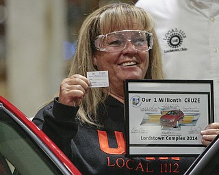        ROBERT K. YOSAY  | THE VINDICATOR..Sharon Frey of Mineral RIdge.. holds the certificate that the car is the 1 millionith Cruze built shortly after she won the cruze in a drawing with her is Glenn Johnson UAW 1112..UAW Locals 1112 and 1714 purchased the one millionith Cruze  that was  raffled to a Lordstown UAW team member. (Sharon Frey of Mineral Ridge.- Raffle proceeds beyond the cost of the Cruze were donated to the St. Vincent DePaul Society of Youngstown. US REp Sherrod Brown will drew the winning name. ..-30-