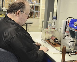 Katie Rickman | The Vindicator.Dave Ludt tests coils at Altronic in Girard on Thursday, Oct. 16, 2014.