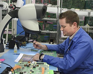 Katie Rickman | The Vindicator.John Chetsko an industrial and manufacturing engineer at altronic Hoerbiger Engine Solutions works on at a station at the facility in Girard on Thursday, Oct. 16, 2014.