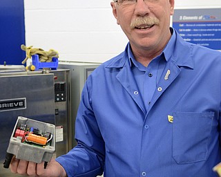 Katie Rickman | The Vindicator.Doug Cirbus, Vice President of Operations at altronic Hoerbiger Engine Solutions shows machinery used in the process of manufacturing components used in GTI Bi-fuel system which is made at the Girard facility.