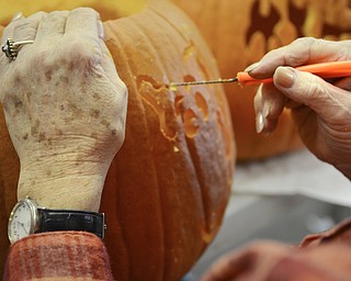Katie Rickman | The Vindicator.Karen Anderson of Boardman carves out the details in one of the pumpkins she worked on at the volunteer pumpkin carving event on Thursday, Oct 16, 2014.