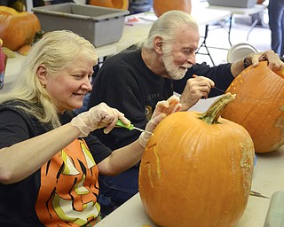 Katie Rickman | The Vindicator.Doris Pivarnik and her husband Edward of Poland carve pumpkins side-by-side at Fellows Riverside Gardens on Thursday, Oct. 16, 2014. The couple have volunteered ever year for 5 years.