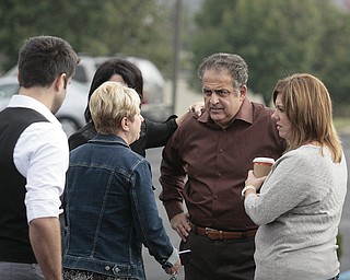        ROBERT K. YOSAY  | THE VINDICATOR..Atty Dave Betras talks with office workers as he waited for the Sheriffs Dept and the Youngstown Bomb Squad to deactivate the pipe bomb ..The Youngstown Police Dept  bomb squad set off what appeared to be a pipe bomb outside a broken window at the Betras, Harshman and Kopp law office in Canfield on Seville Dr...that ended up not being explosive....-30-