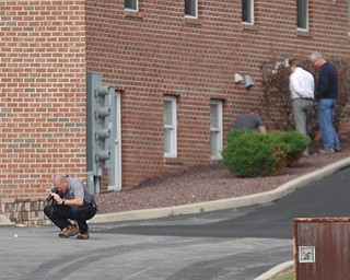        ROBERT K. YOSAY  | THE VINDICATOR..Youngstown Police Dept Bomb Squad and Mahoning County Sheriffs Dept .. investigate the area where the supposed pipe bomb was detonated...The Youngstown Police Dept  bomb squad set off what appeared to be a pipe bomb outside a broken window at the Betras, Harshman and Kopp law office in Canfield on Seville Dr...that ended up not being explosive....-30-