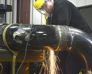 Katie Rickman | The Vindicator.Martin Higham welds piping for a compressor that is manufactured at Dearing Compressor and Pump Company in Youngstown on Friday, Oct. 17, 2014.