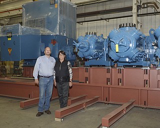 Katie Rickman | The Vindicator.Rick Dearing and his sister Becky Dearing pose for a photo in front of a compressor that was made in the shop at their family-run business Dearing Compressor and Pump Company in Youngstown on Friday Oct. 17, 2014.