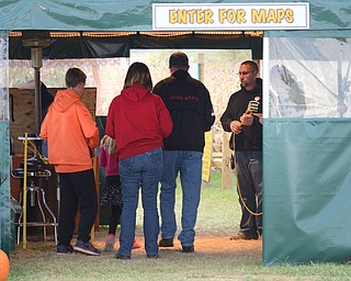 Katie Rickman | The Vindicator.Mike Bacon, far right, gives an informational speech to a group of newcomers to the Maze Craze that he and his wife Cindy own and run in New Springfield on Friday, Oct. 17, 2014.