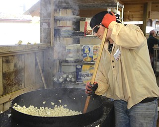 Katie Rickman | The Vindicator.Derrick McDonald of Girard pops kettle corn for The Popcorn Man at Christmas in the Woods on Saturday, Oct. 18, 2014.