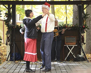 Katie Rickman | The Vindicator.Ken and Carol Swisher of Smithville, Ohio who are a part the Cedar Valley Gloggers, a traditional Appalachian clogging group, dance a waltz in front of a small crowd at Christmas in the Woods on Saturday, Oct. 18, 2014.
