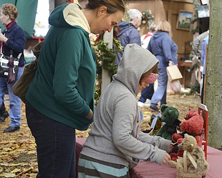 Katie Rickman | The Vindicator.Lia McTrustry, 8, of East Palestine and her mother Beth look at teddy bears at Christmas in the Woods on Saturday, Oct. 18, 2014.