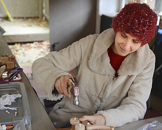 Katie Rickman | The Vindicator.Cheryl Bier the owner "Mama Made Them" based out of Weirton, West Virginia hammers on wheels of one of her home-made toys at Christmas in the Woods in Columbiana on Saturday, Oct. 18, 2014.