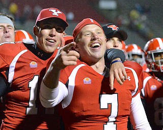 Jeff Lange | The Vindicator  Joey Cejudo (left) and Tanner Garry (7) sing the Youngstown fight song after defeating Southern Illinois 26-14, Saturday night at Stambaugh Stadium.