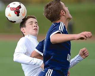 Jeff Lange | The Vindicator  Ursuline's Brendan Faloon (back) heads the ball behind the defense of United's Andrew Williams, Saturday afternoon during their sectional final game held at YSU.