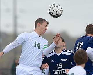 Jeff Lange | The Vindicator  Ursuline's John Hintz heads the ball over United's Nick Varaglotti (15) and Andrew Martin (8), Saturday afternoon at YSU.