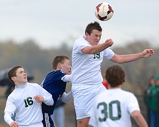 Jeff Lange | The Vindicator  Ursuline junior Dante Rossi (19) heads the ball off a corner kick as he's pressured by Ben Sell (back) from behind as Ursuline's Brendan Faloon (16) and Patrick Conway (30) look on at the play, Saturday afternoon at YSU.