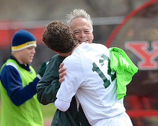 Jeff Lange | The Vindicator  Ursuline head coach Roy Schmidt hugs Gianni Quattro as he comes off the field during second half play against the United Golden Eagles, Saturday afternoon at YSU.
