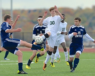 Jeff Lange | The Vindicator  Ursuline's Patrick Conway kicks the ball out from a flock of Eagles defenders, Saturday afternoon at YSU.