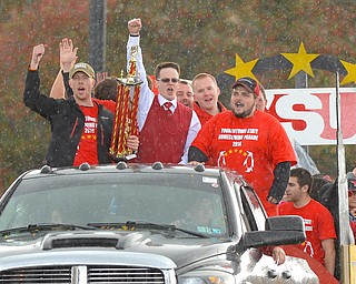 Jeff Lange | The Vindicator  YSU students on the Youngstown Sheet & Tube Co. float show their spirit in the rainy weather, Saturday afternoon before Youngstown's Homecoming game.