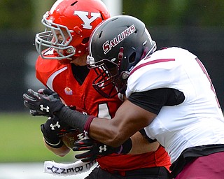 Jeff Lange | The Vindicator  Penguins' Nate Adams is hit hard in the side by Southern Illinois defender Anthony Thompson during second quarter action in Youngstown, Saturday night.