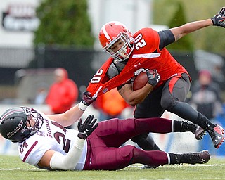 Jeff Lange | The Vindicator  Youngstown's Jody Webb is yanked down by his collar in the backfield by Salukis defender Jefferson Vea (24) in the second quarter of Saturday night's matchup at Stambaugh Stadium.