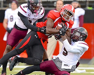 Jeff Lange | The Vindicator  Youngstown wide receiver Andrew Williams is brought down by two Southern Illinois defenders Courtney richmond (left) and Kenny James (right) during first half action in Youngstown, Saturday night.