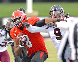 Jeff Lange | The Vindicator  Youngstown's Jelani Berassa (8) pushes back a Salukis defender Kenny James (9) after his reception in the third quarter at Stambaugh Stadium, Saturday night.