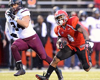 Jeff Lange | The Vindicator  Penguins' wide receiver Andre Stubbs (4) runs for yards during fourth quarter action against the Southern Illinois Salukis, Saturday night at Stambaugh Stadium. Salukis' Jefferson Vea runs on behind.