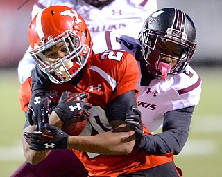 Jeff Lange | The Vindicator  Youngstown's Jody Webb is tackled from behind by Salukis' defender Courtney Richmond in fourth quarter action, Saturday night at Stadmbaugh Stadium.