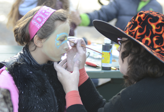 Katie Rickman | The Vindicator.Isabella Sarno, 6, of Campbell has her face painted by Lind Gens, Executive Director of Iron Soup Historical Preservation Company during the Fall Festival hosted by Campbell Pride at Roosevelt Park in Campbell on Sunday, Oct. 19, 2014.