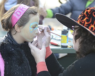 Katie Rickman | The Vindicator.Isabella Sarno, 6, of Campbell has her face painted by Lind Gens, Executive Director of Iron Soup Historical Preservation Company during the Fall Festival hosted by Campbell Pride at Roosevelt Park in Campbell on Sunday, Oct. 19, 2014.