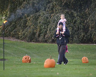 Katie Rickman | The Vindicator.Fred Anderson of Struthers gives his daughter a lift through Fellows Riverside Garden to look at the hundreds of pumpkins that were carved for The Pumpkin Walk on Sunday, Oct. 19, 2014.