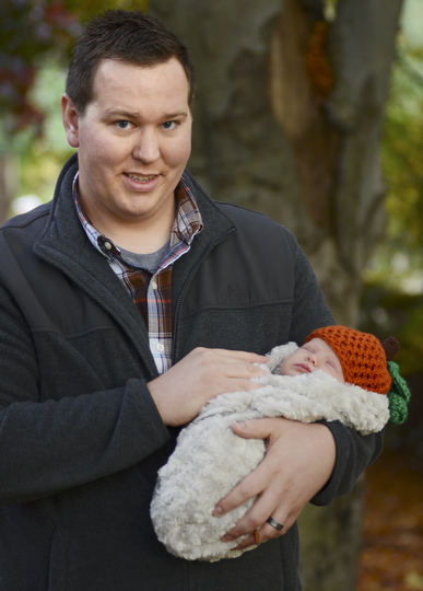 Katie Rickman | The Vindicator.Mark Wooten of Poland holds his 3-week-old daughter named Maisy as he and his family attend The Pumpkin Walk at Fellows Riverside Gardens on Sunday, Oct. 19, 2014.