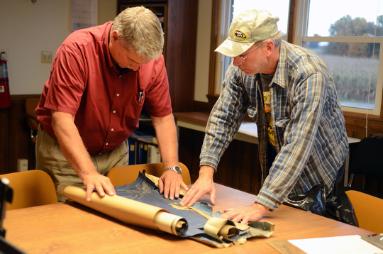 Katie Rickman | The Vindicator Bill Long, right, of Minerva shows abounded mine blue prints from his home to Jim Bishop, Abandoned Mine Lands Adminisitrator at ODNR, Long found the blueprints at his home.