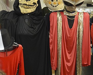 Katie Rickman | The Vindicator.A Grim Reaper costume stands next to and alien with a scarecrow behind them at Ward Costume Shoppe in Niles on Monday, Oct. 20, 2014.