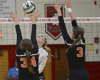 Katie Rickman | The Vindicator.Mooney's Maddie Abrigg (19) serves a ball over the net as Mineral Ridge's Anna Bodo (34) and Breanna Miner attempt to block the hit during the 3rd period of the district semifinal at  Salem High School on Wednesday, Oct. 22, 2014.