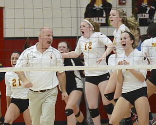 Katie Rickman | The Vindicator.Tony Gorvet, head coach of Mooney's volleyball team celebrates as members of the team jump up behind him after Mooney beat Mineral Ridge at the district semifinals at Salem High School on Wednesday, Oct. 22, 2014.