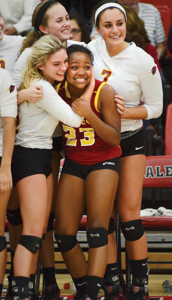 Mooney’s Makenna Ozenghar, left, embraces Lauren Lottier after the Cardinals downed the Mineral Ridge Rams, 3-1, in a Division III volleyball district final Wednesday at Salem High School. Ozenghar not only stepped in for injured teammate Gina Patella, but she also provided the turning point for the Cardinals.