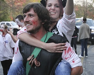 William D. Lewis the Vindicator   Rick Price of Boardman carries Elena Rapone of Youngstown during Zombie Crawl.